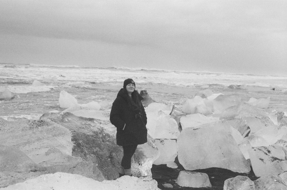 People among ice on the black sand at Diamond Beach